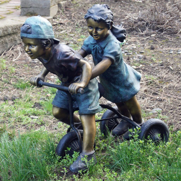 Bronze statues of boys and girls riding bicycles