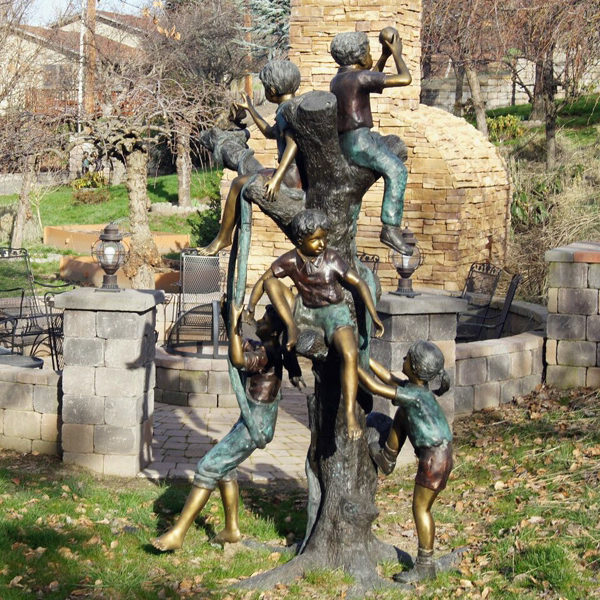 Bronze statue of children playing in a tree
