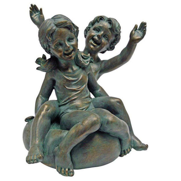 bronze statue of boy and girl sitting on a stone