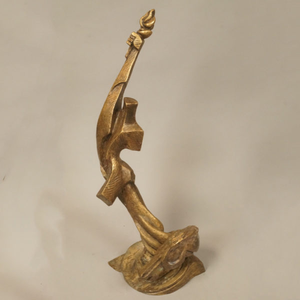 Abstract bronze sculpture holding a torch