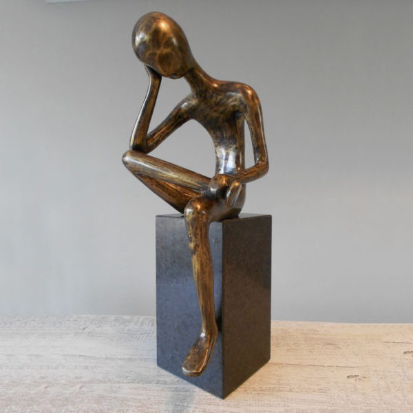 Bronze sculpture of a man thinking abstractly