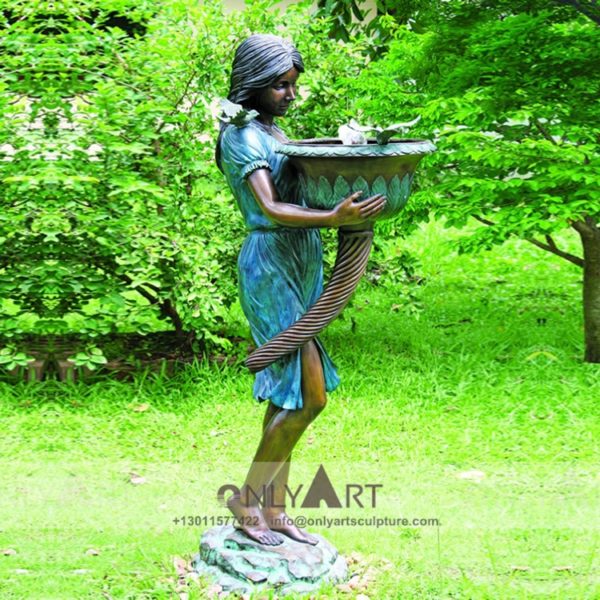 Fountain sculpture of a bronze maiden holding a pot adorns the garden